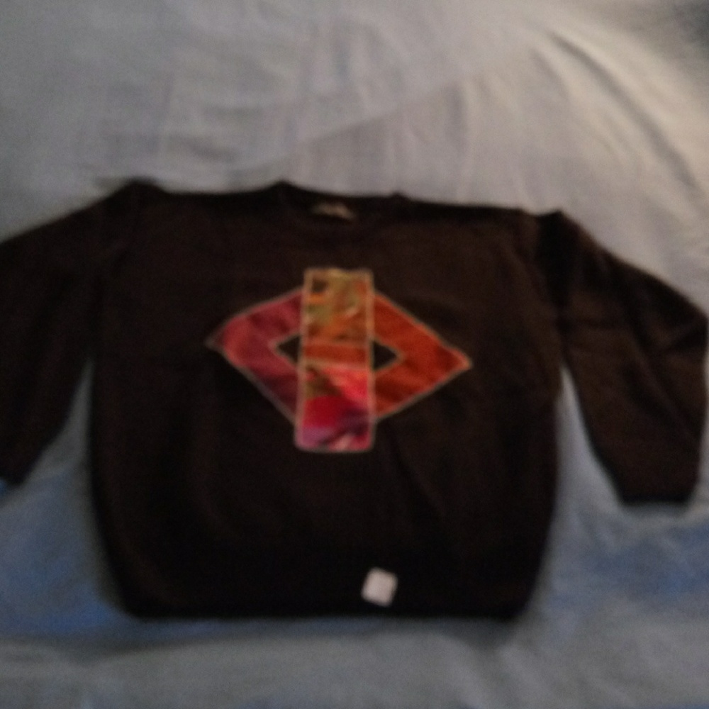 Black acrylic sweater with colorful fabric designs
